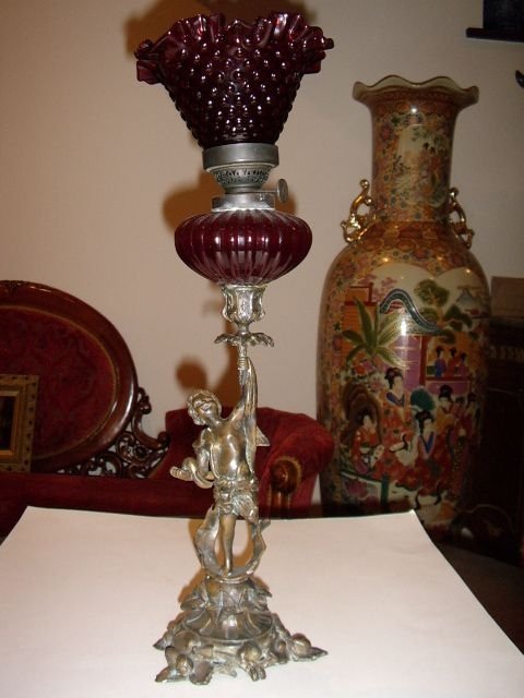 bronze cherub candlestick oil lamp with cranberry glass shade c1850