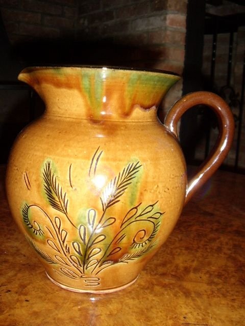 early glazed earthenware farmhouse jug decorated with wheat design