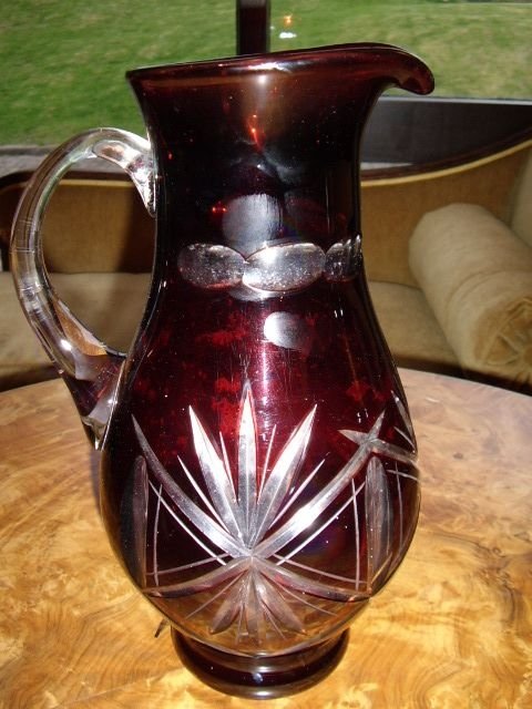 large dark ruby cut glass pouring jug with star cut design