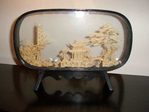 hand crafted cork carving depicting oriental house with trees birds in glass case on stand