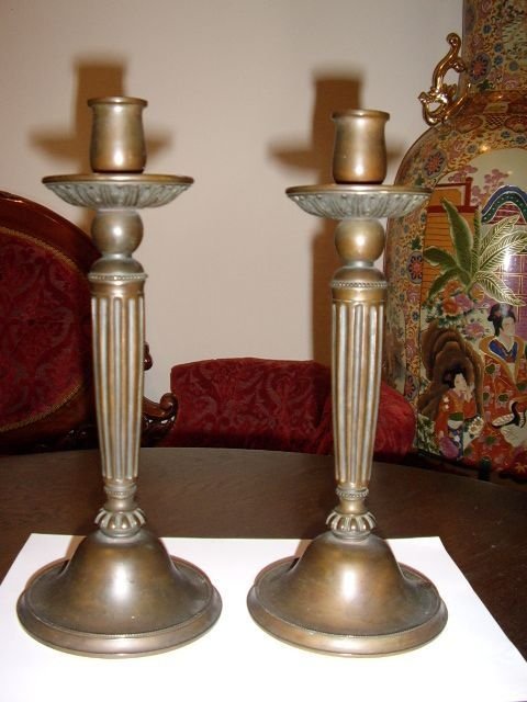 a pair of bronze candlesticks 115 inches high