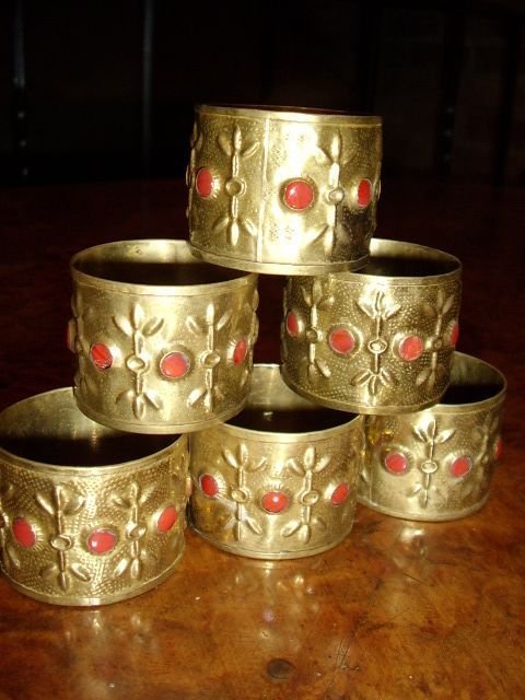 set of 6 hand made brass napkin rings inset with red correl made in london