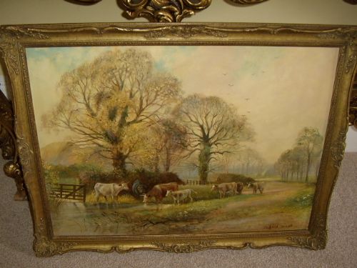 fine oil painting on panel of cattle watering besides a flooded dirt track by listed artist richard temple presented in the original period plaster gilt decorative frame measuring 34 x 26 inches